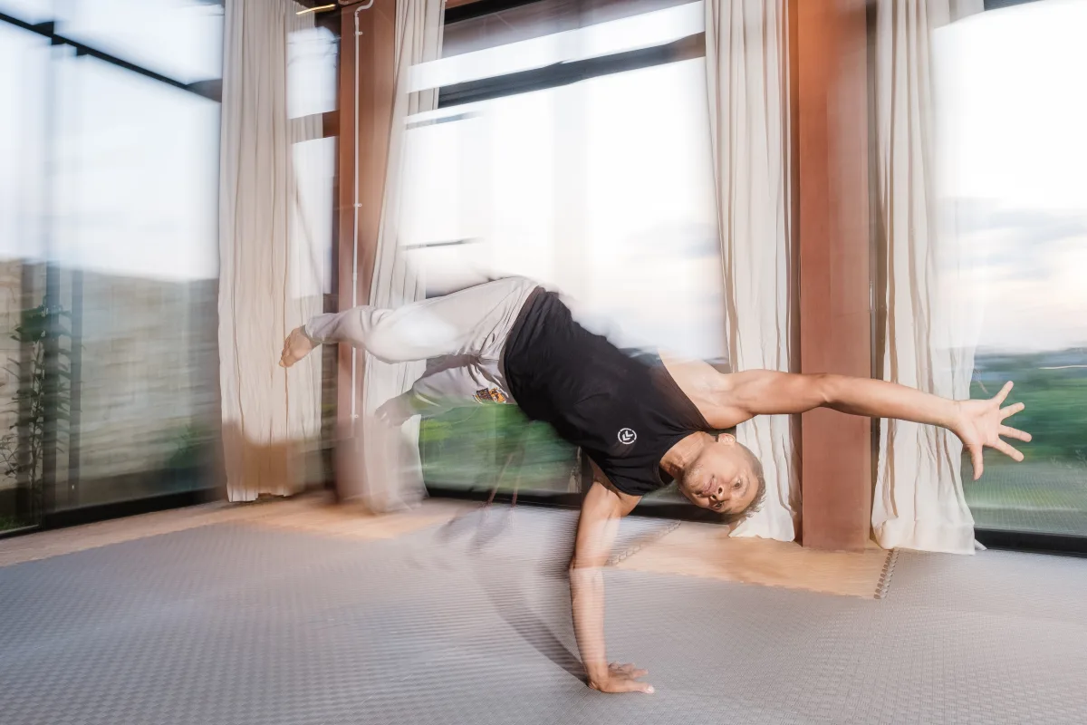 Capoeira teacher moving through a hand-supported transition
