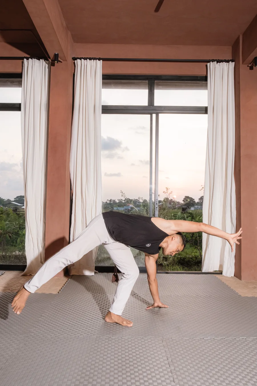 Capoeira teacher extending through a grounded movement shape