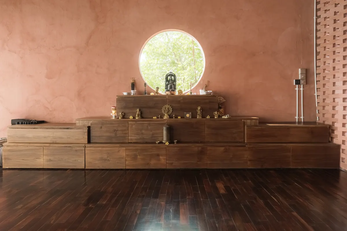 The VedicPath yoga shala with warm wooden floors and a quiet altar
