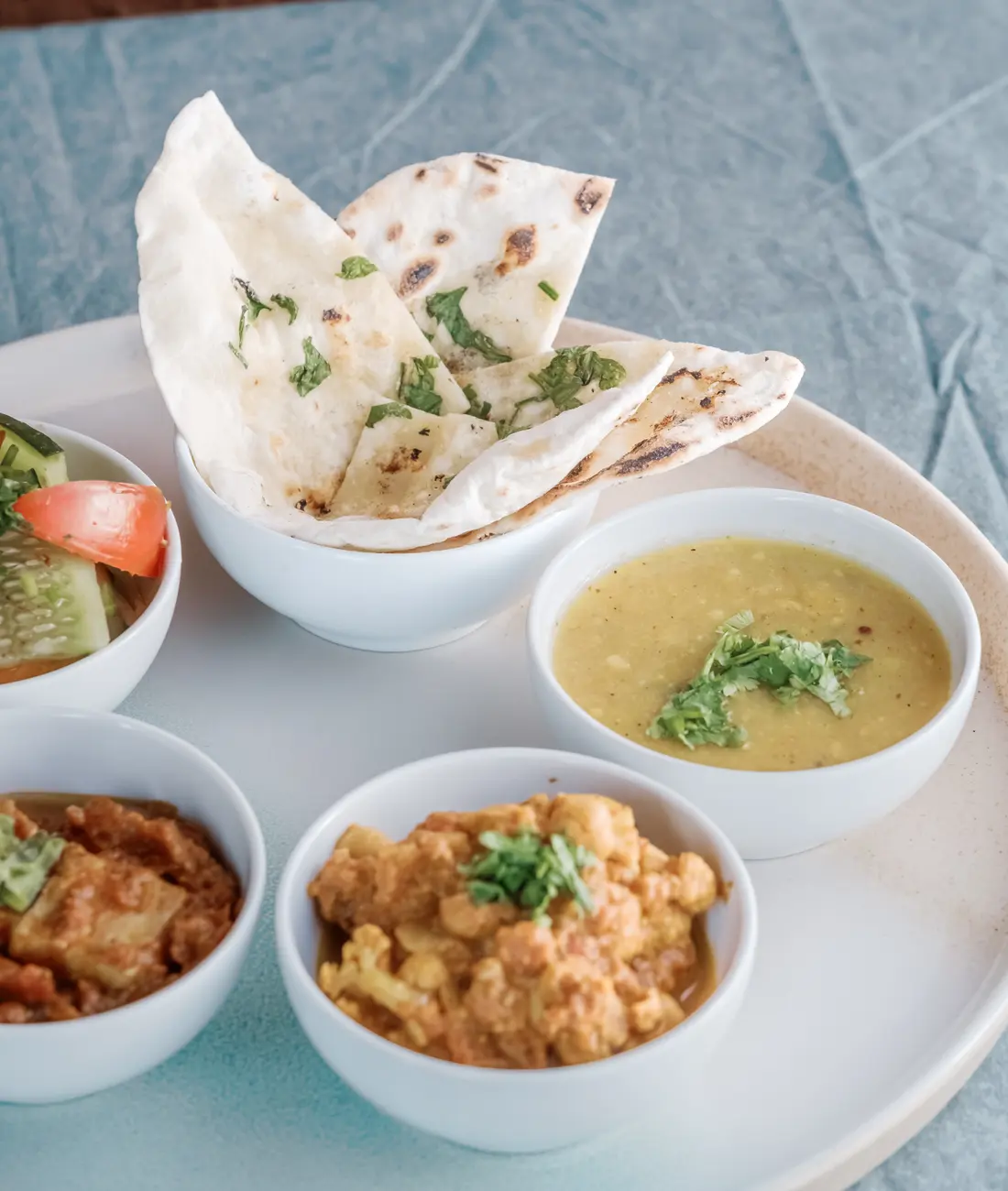 A Vedic Kitchen thali with rice, dal, vegetables, and fresh sides