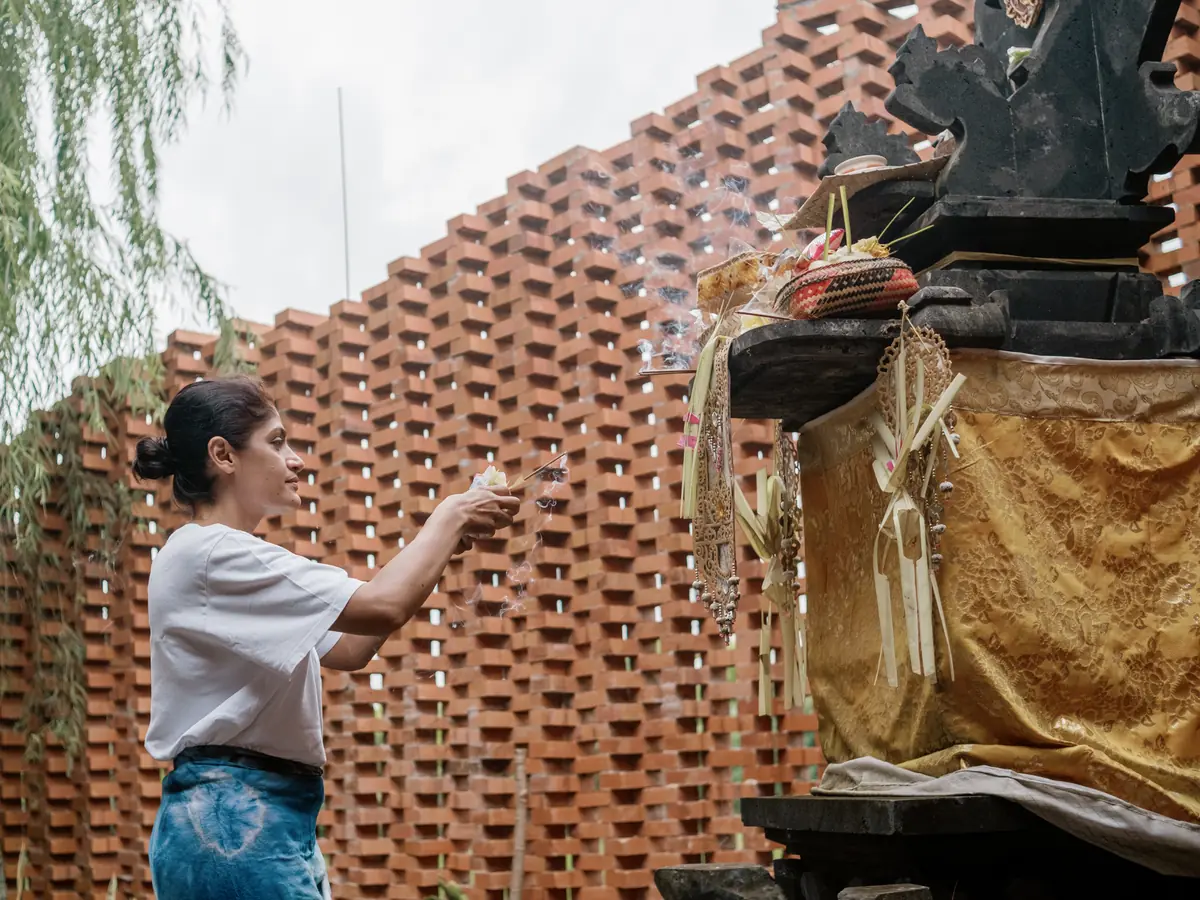 A community blessing moment beside the Vedic Path courtyard wall